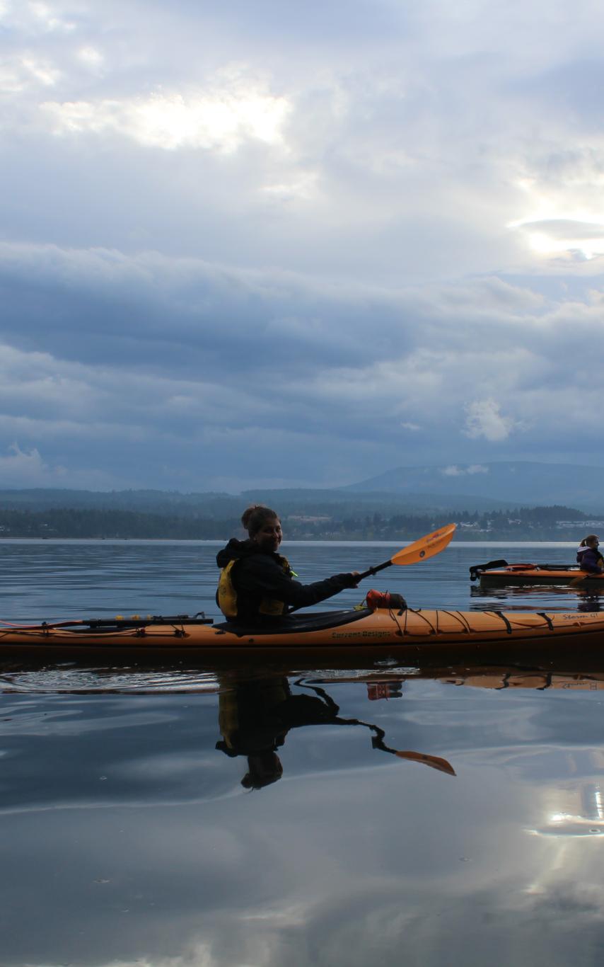 Paddlers in kayaks on the ocean